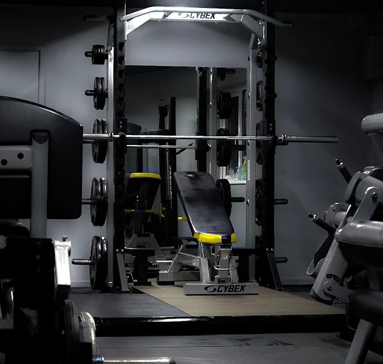 Cybex Smith machine with an adjustable bench and loaded plates on the lifting platform at Bodyworks Gym Featherstone