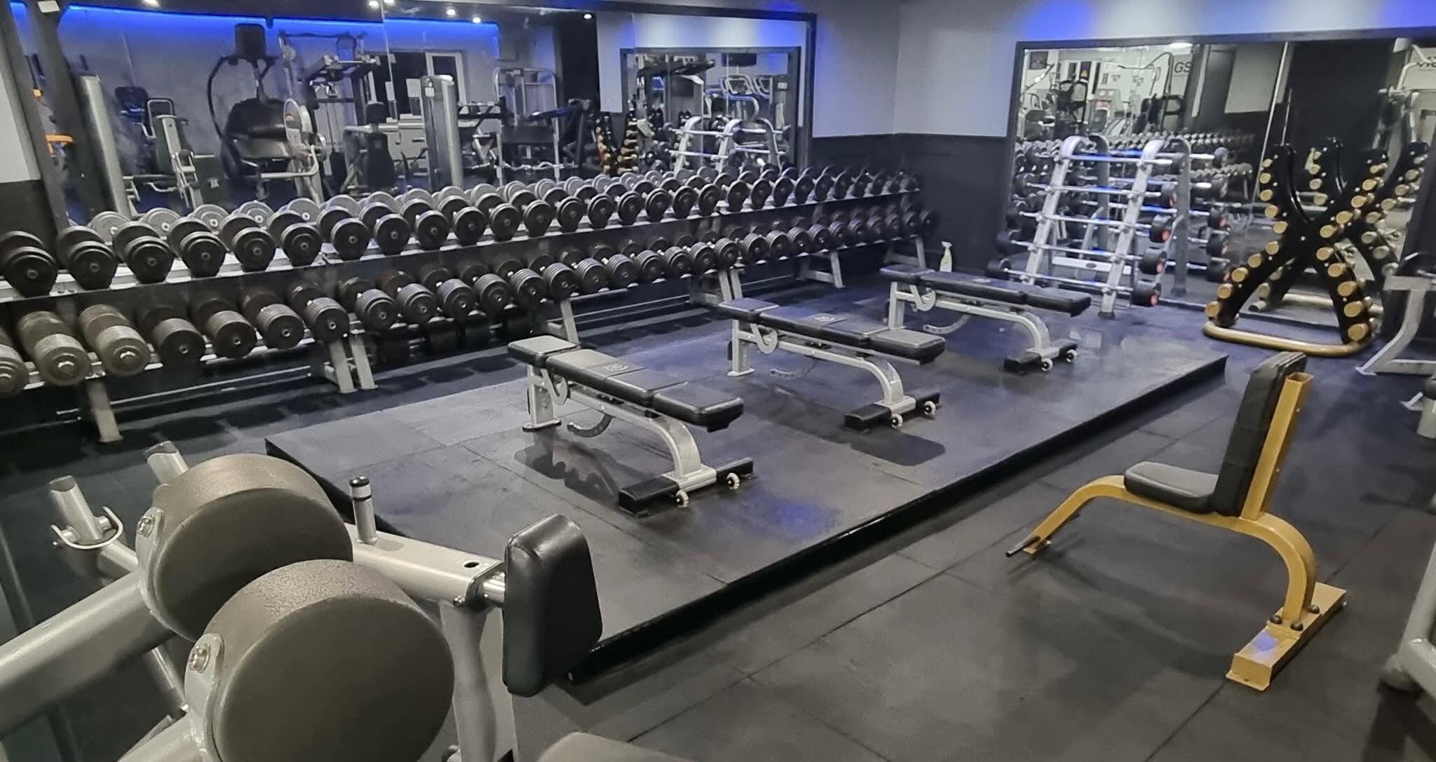 Full dumbbell rack and flat benches on the free-weights platform at Bodyworks Gym Featherstone
