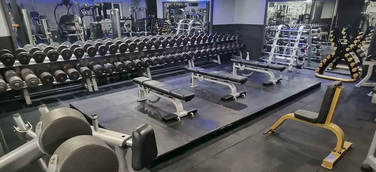The free-weights area at Bodyworks Gym Featherstone, with a full dumbbell rack and benches